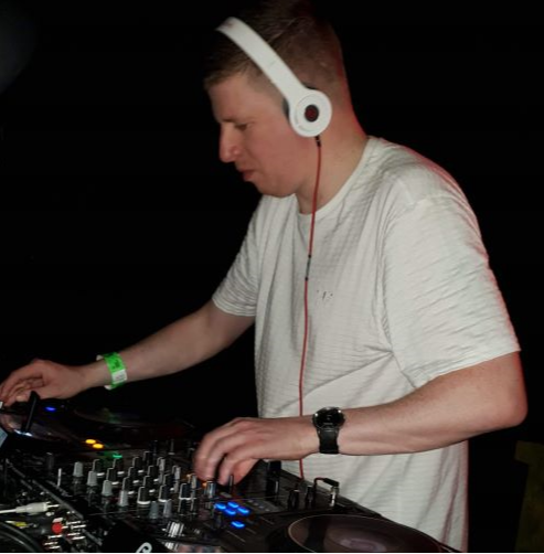Brysi performing behind the DJ decks